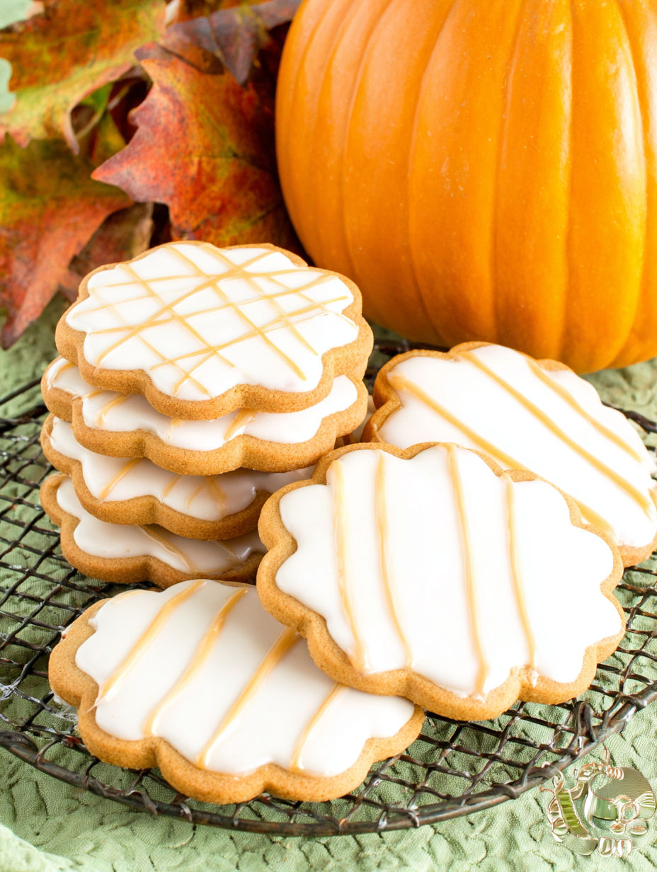 A stack of pumpkin spice sugar cookies with maple icing.