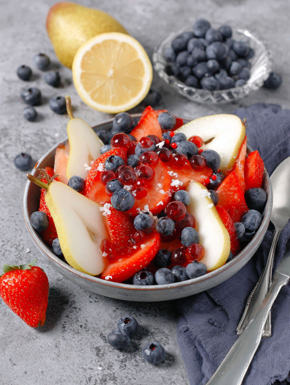 A bowl of fruit salad with blueberries, strawberries, and lemon.