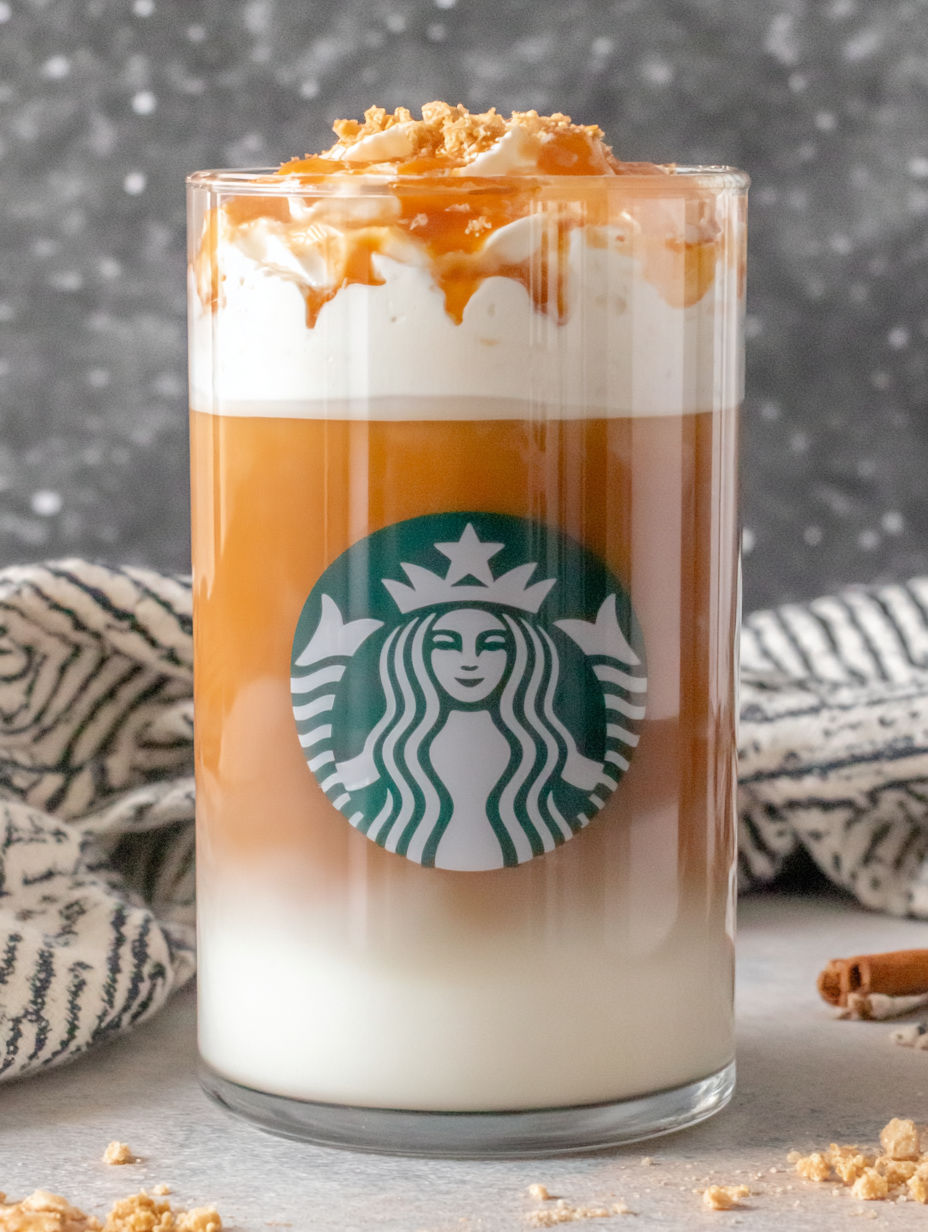 A glass of Starbucks coffee with a caramel topping.
