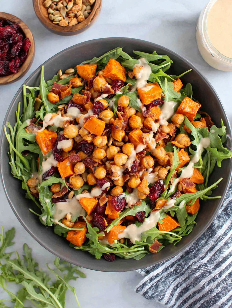 A bowl of roasted chickpea and sweet potato salad with sweet tahini dressing.