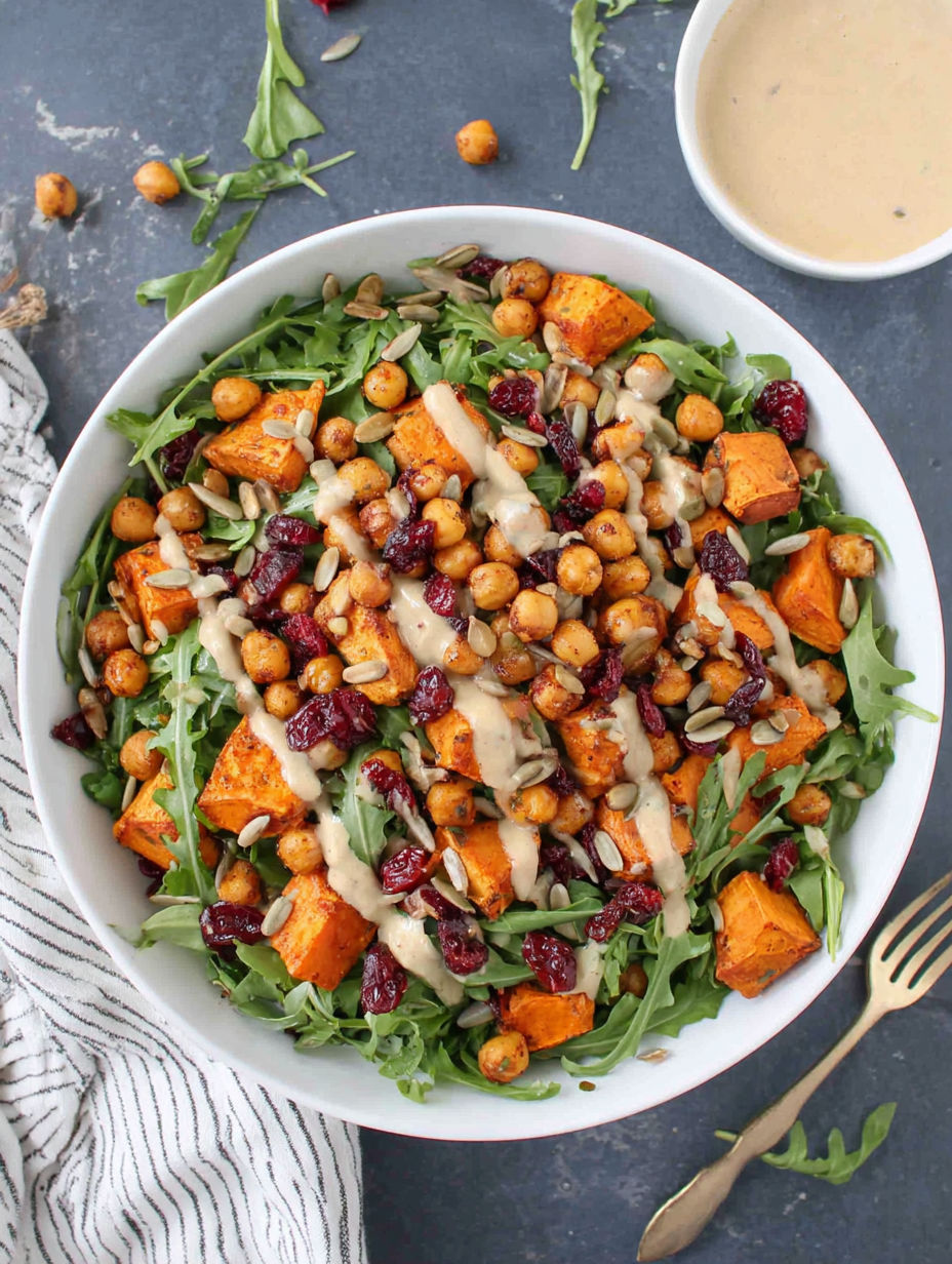 A bowl of roasted chickpea and sweet potato salad with a sweet tahini dressing.