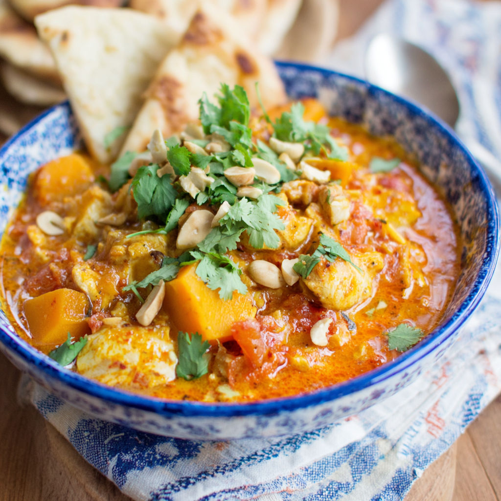 A bowl of chicken and butternut squash curry.