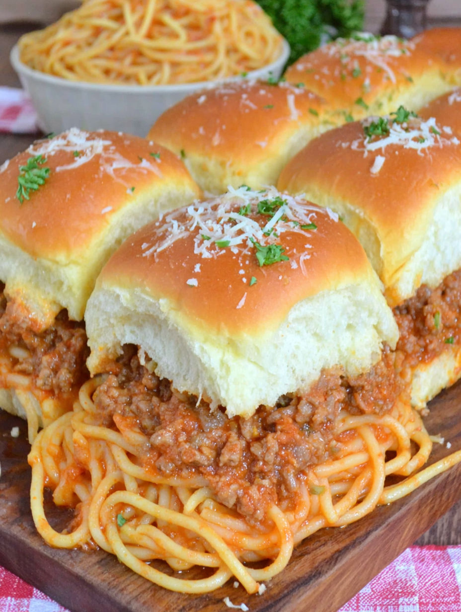 A plate of food with a sandwich and spaghetti.