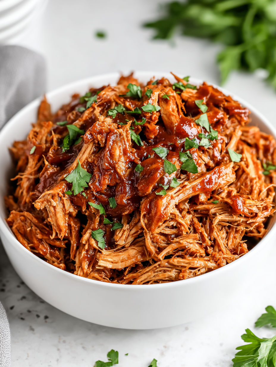 A bowl of meat with green onions on top.
