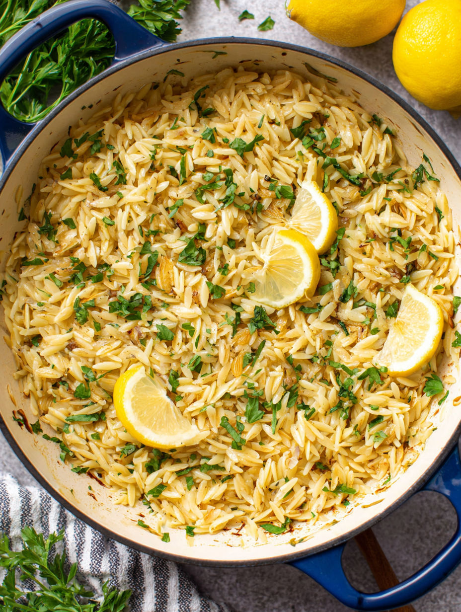A bowl of rice with lemon and herbs.
