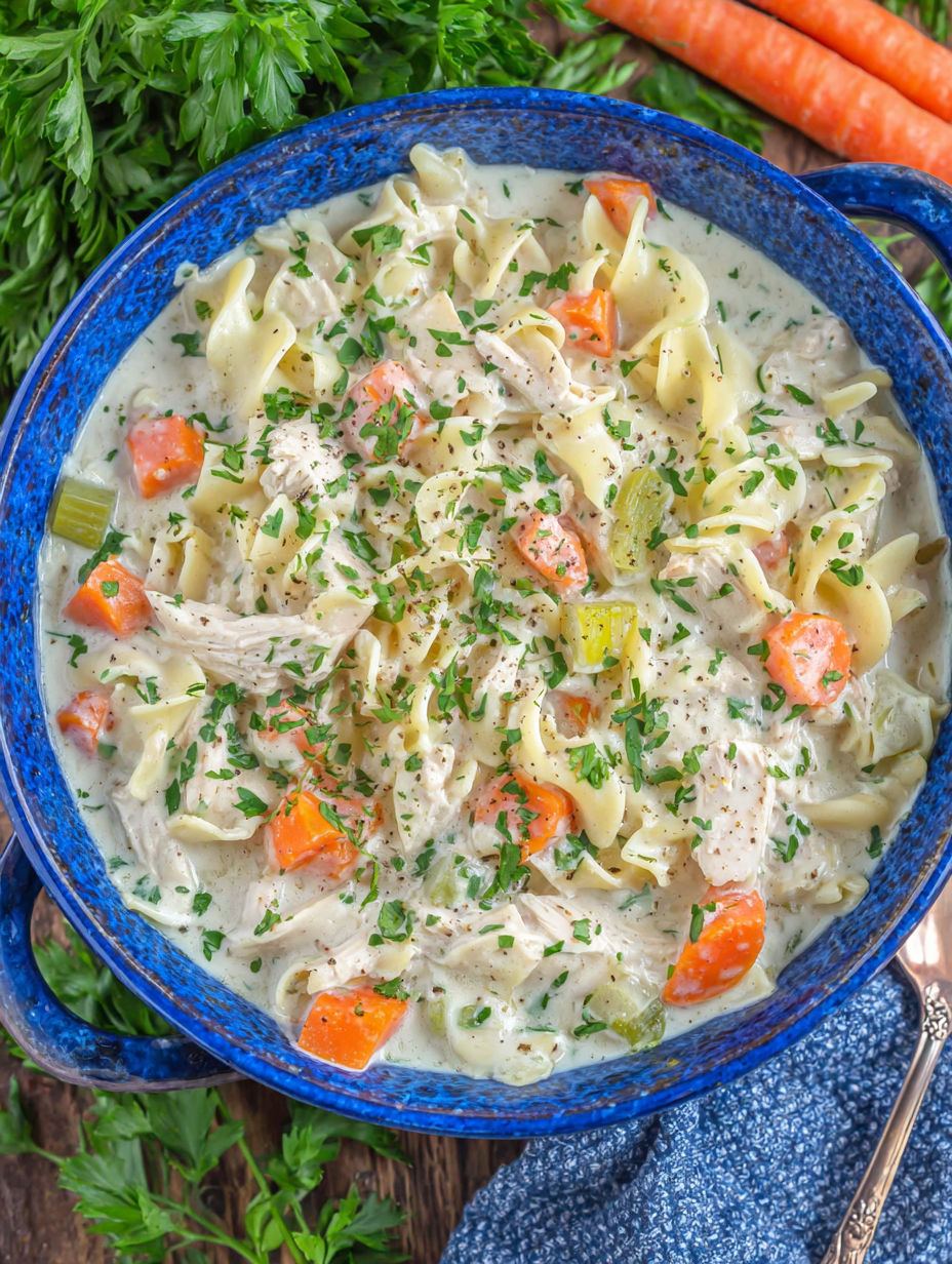 A bowl of creamy chicken noodle soup.