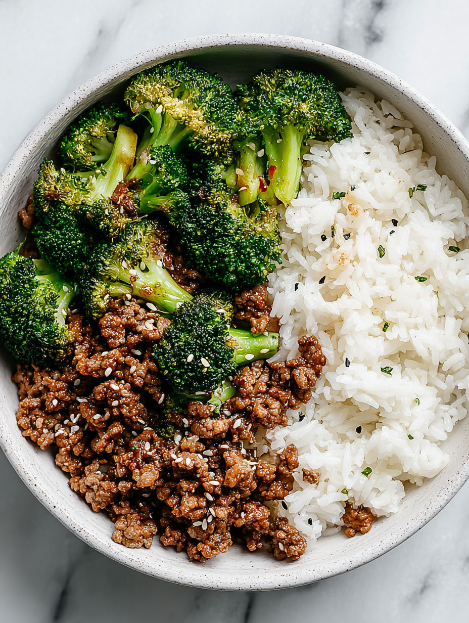 A bowl of ground beef and broccoli stir fry with rice.