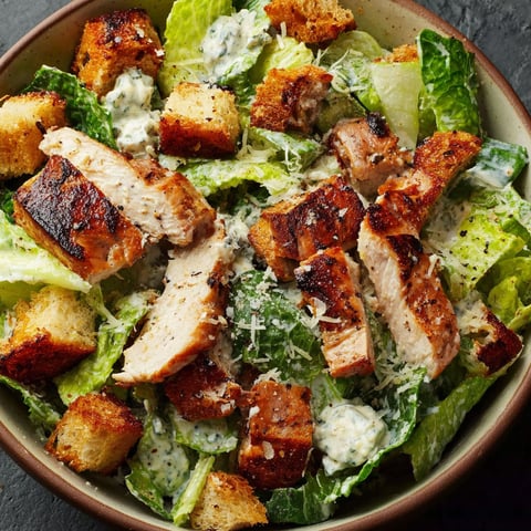 A bowl of chicken Caesar salad.