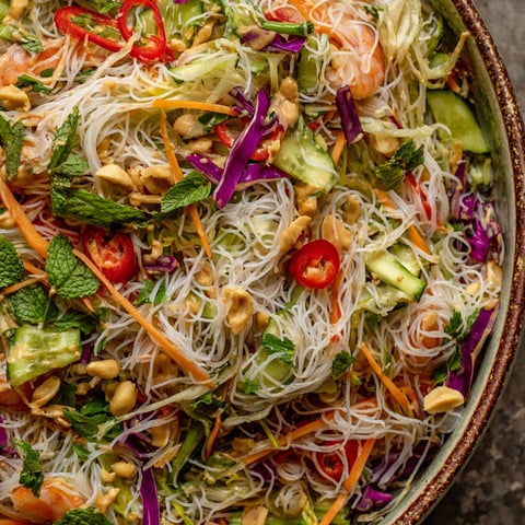 A bowl of spring roll salad with peanut dressing.