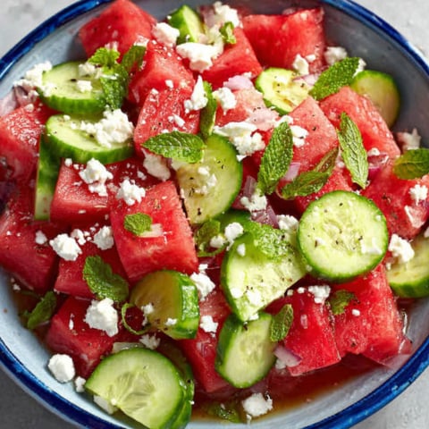 A bowl of watermelon, cucumber, and feta cheese.