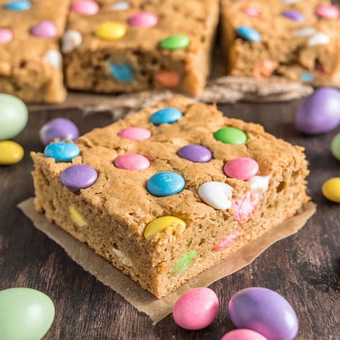 A piece of Easter blondies with colorful candy on top.
