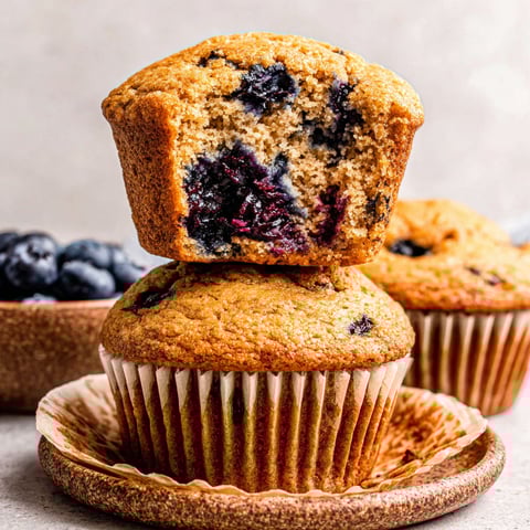 A stack of blueberry muffins on a plate.