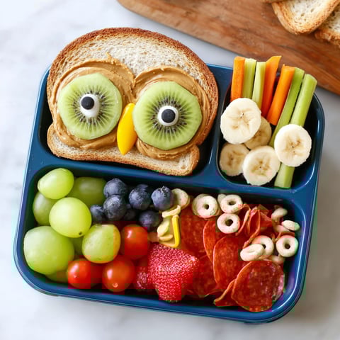 A fun lunch idea for kids includes a sandwich, fruits, vegetables, and crackers.