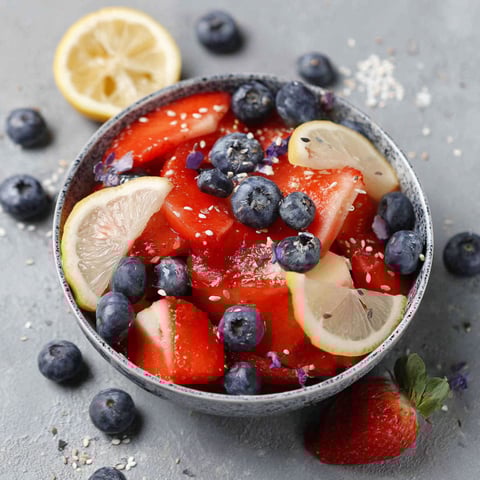 A bowl of red, white and blue fruit salad.