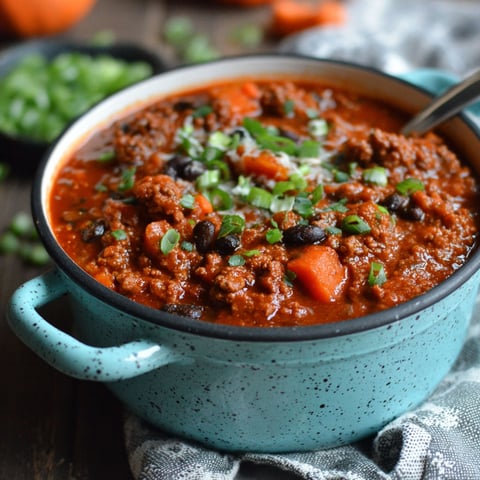 A bowl of chili with pumpkin puree.
