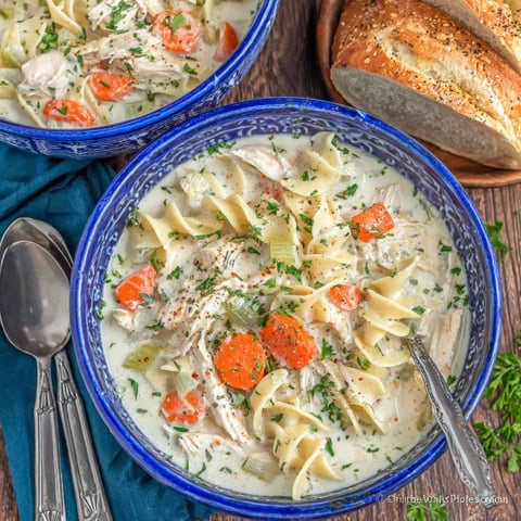 A bowl of creamy chicken noodle soup.