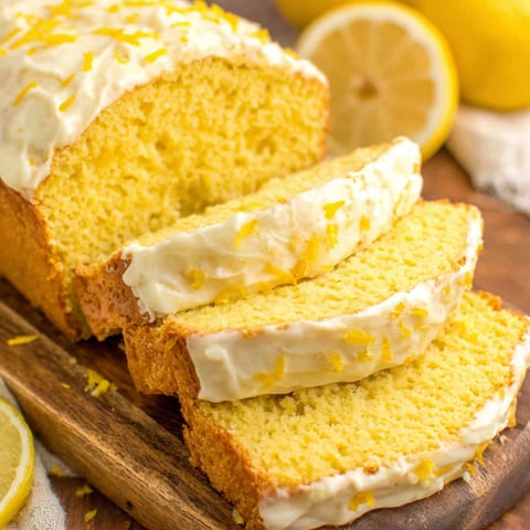 A slice of lemon bread with a lemon on the side.